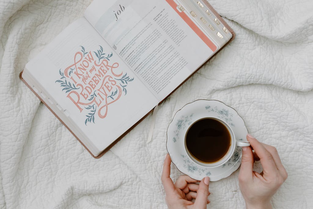 An open Bible with a quote and coffee, embodying a serene morning routine.