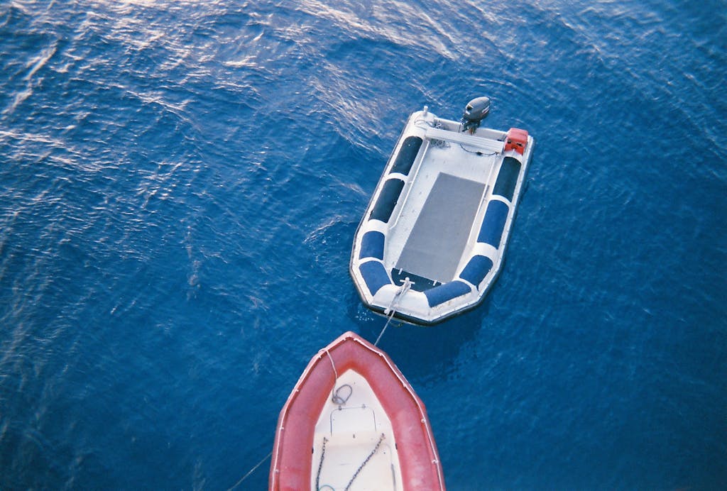 High-angle shot of two motorboats floating on the clear blue ocean near Cairns, Australia.
